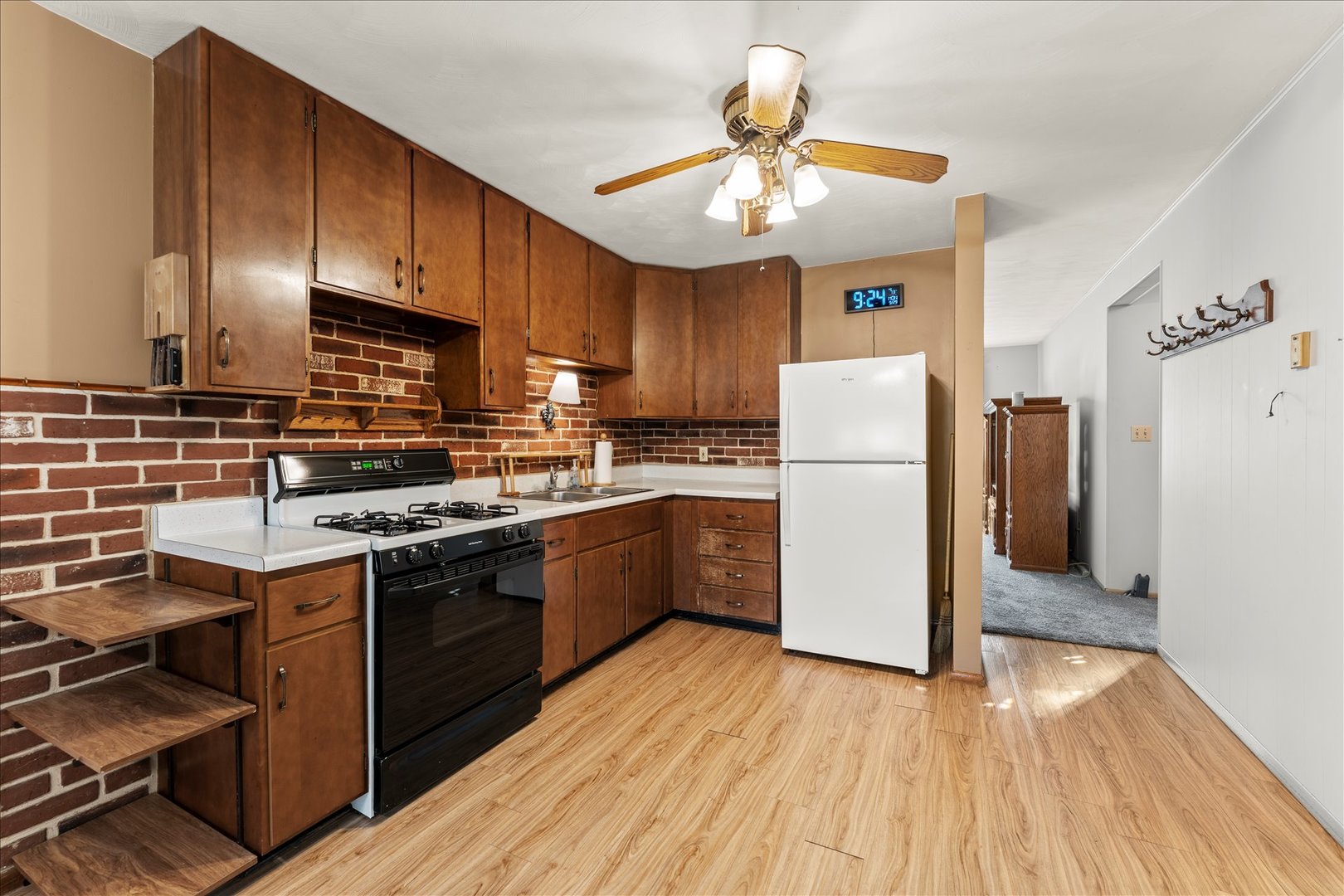 708 Jackson Street Monticello, IL 61856 - Photo 9 of 28 a kitchen with a refrigerator a stove cabinets and wooden floor