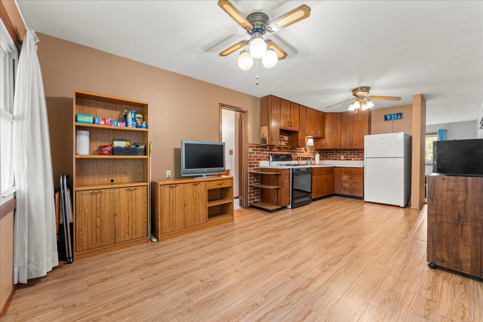 708 Jackson Street Monticello, IL 61856 - Photo 10 of 28 a kitchen with stainless steel appliances a stove top oven a refrigerator cabinets and wooden floor