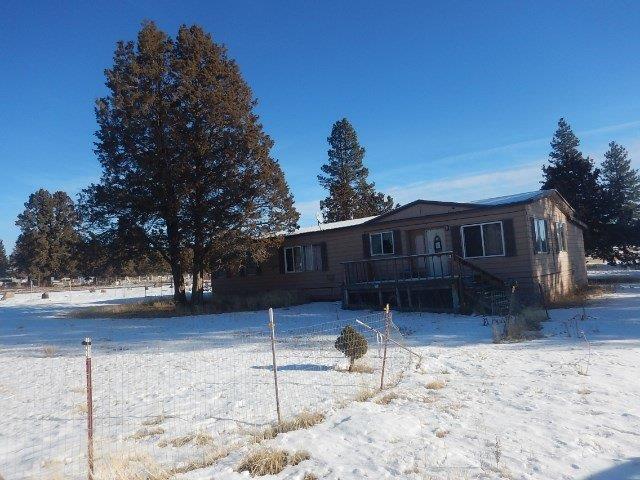 29947 Sprague River Road Chiloquin, OR 97624 - Photo 10 of 12 a front view of a house with a yard covered in snow