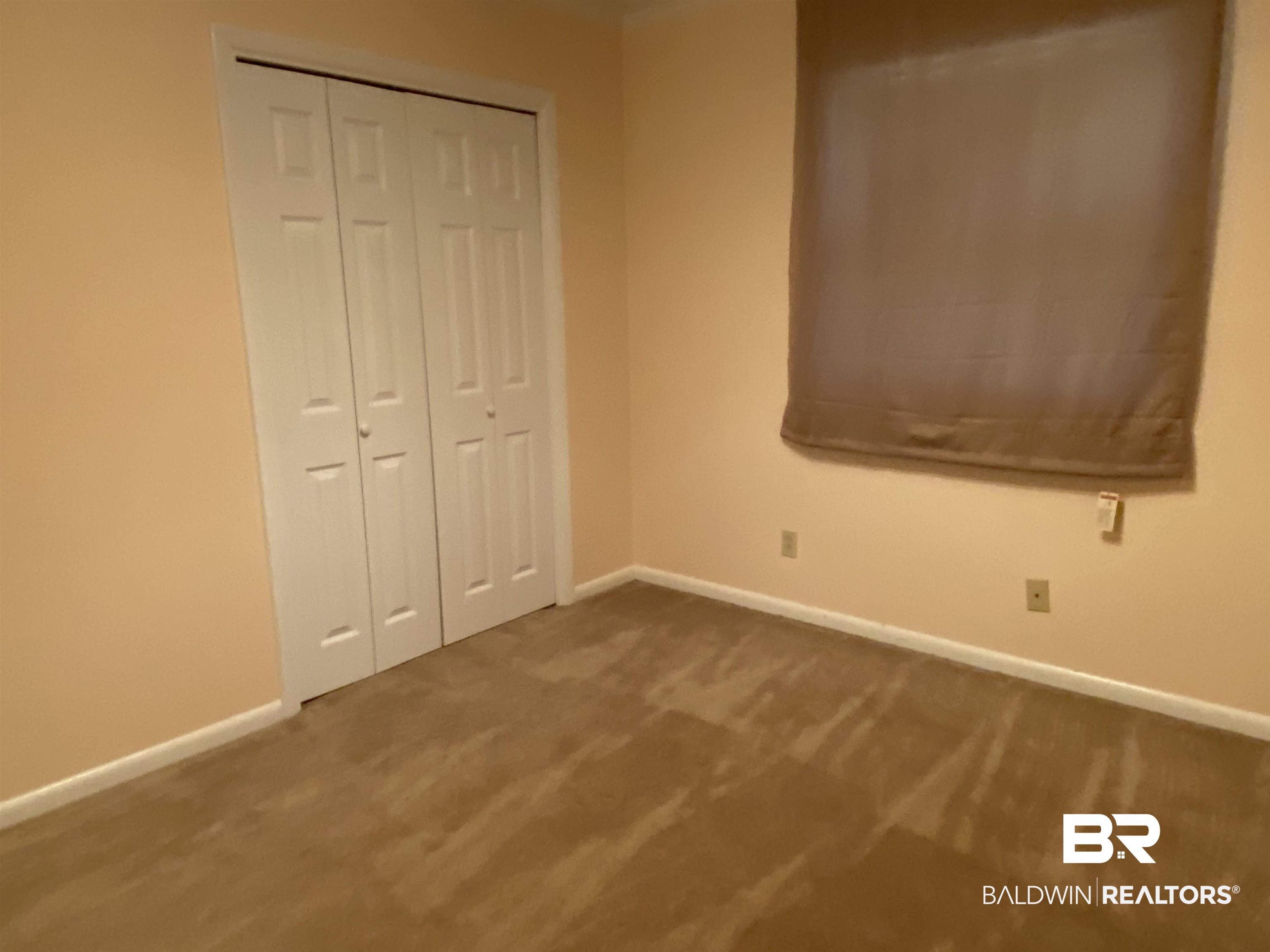 106 Terry Drive Brewton, AL 36426 - Photo 14 of 25 Unfurnished bedroom featuring carpet floors and a closet