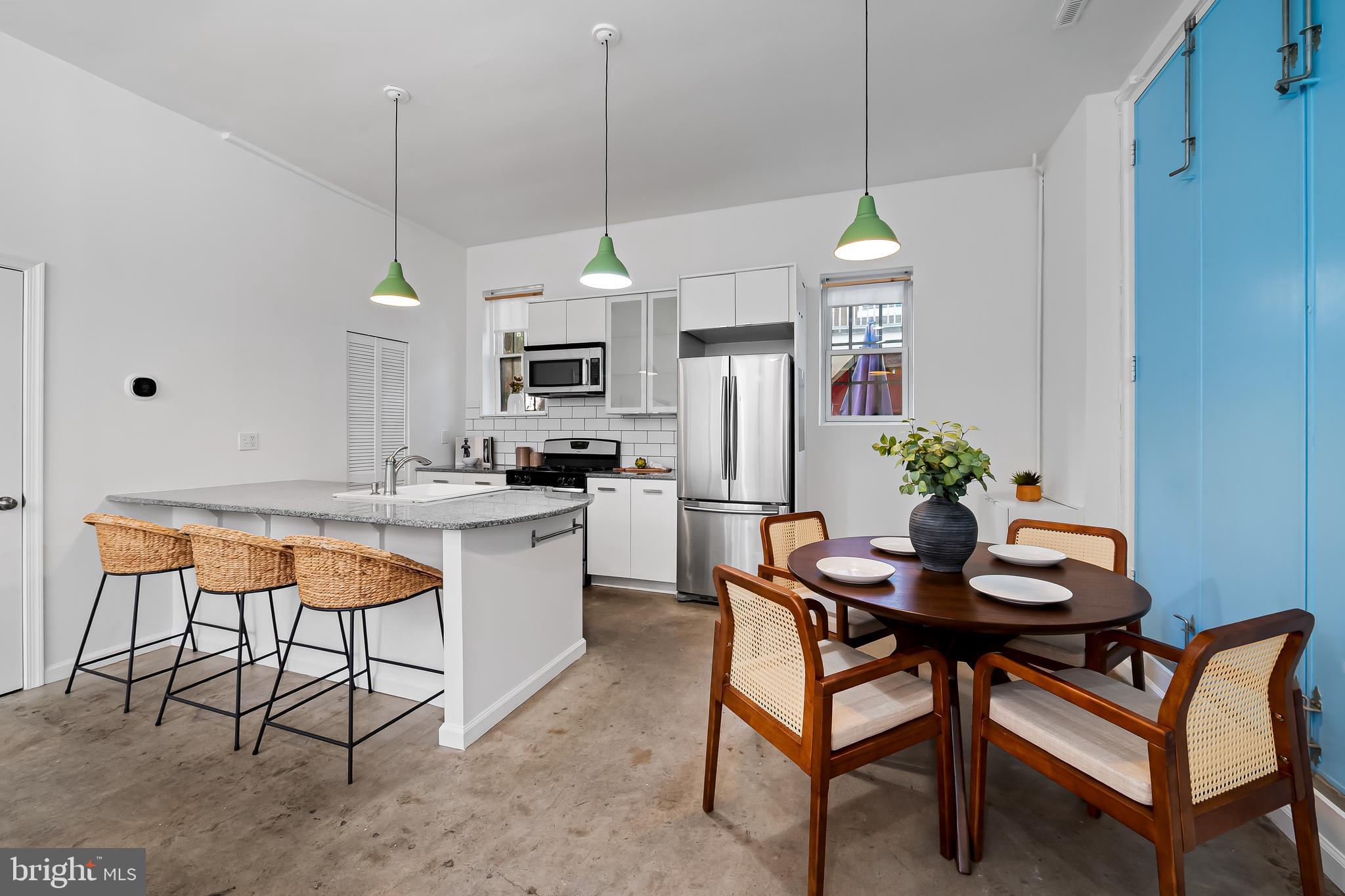 307 Mosher Street Baltimore, MD 21217 - Photo 11 of 30 a room with stainless steel appliances kitchen island granite countertop furniture and a view of kitchen