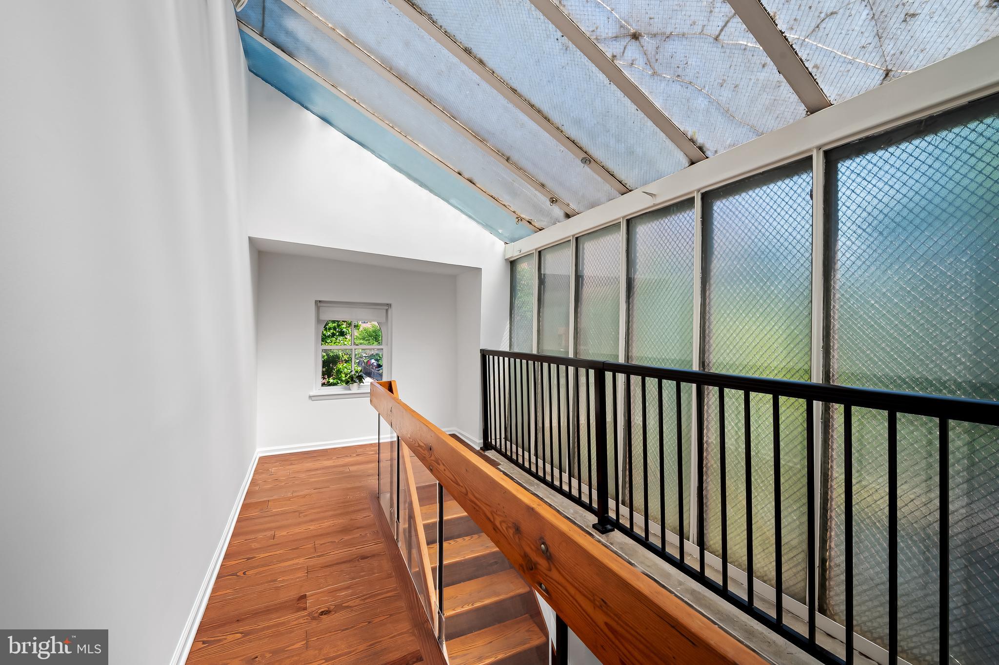 307 Mosher Street Baltimore, MD 21217 - Photo 22 of 30 a view of a hallway with wooden floor and stairs