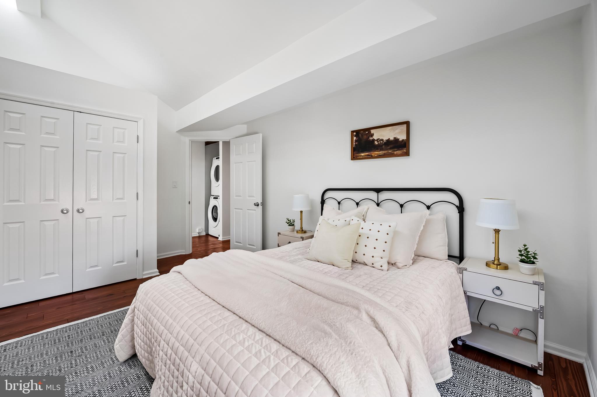 307 Mosher Street Baltimore, MD 21217 - Photo 25 of 30 a bedroom with a large bed and a lamp on dresser