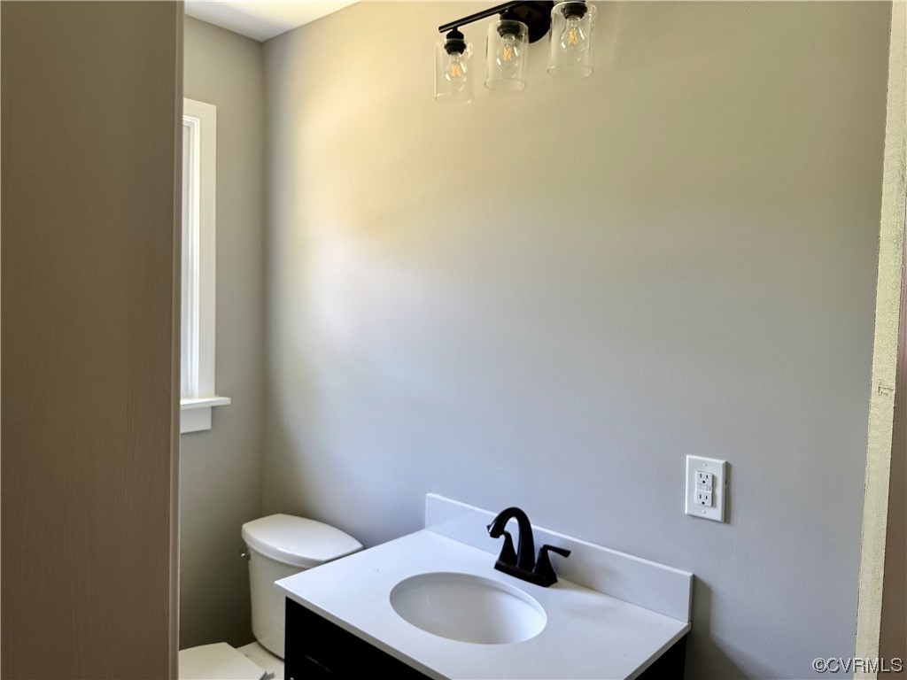1035 Southam Drive Richmond, VA 23235 - Photo 26 of 43 a bathroom with a sink a toilet and a mirror