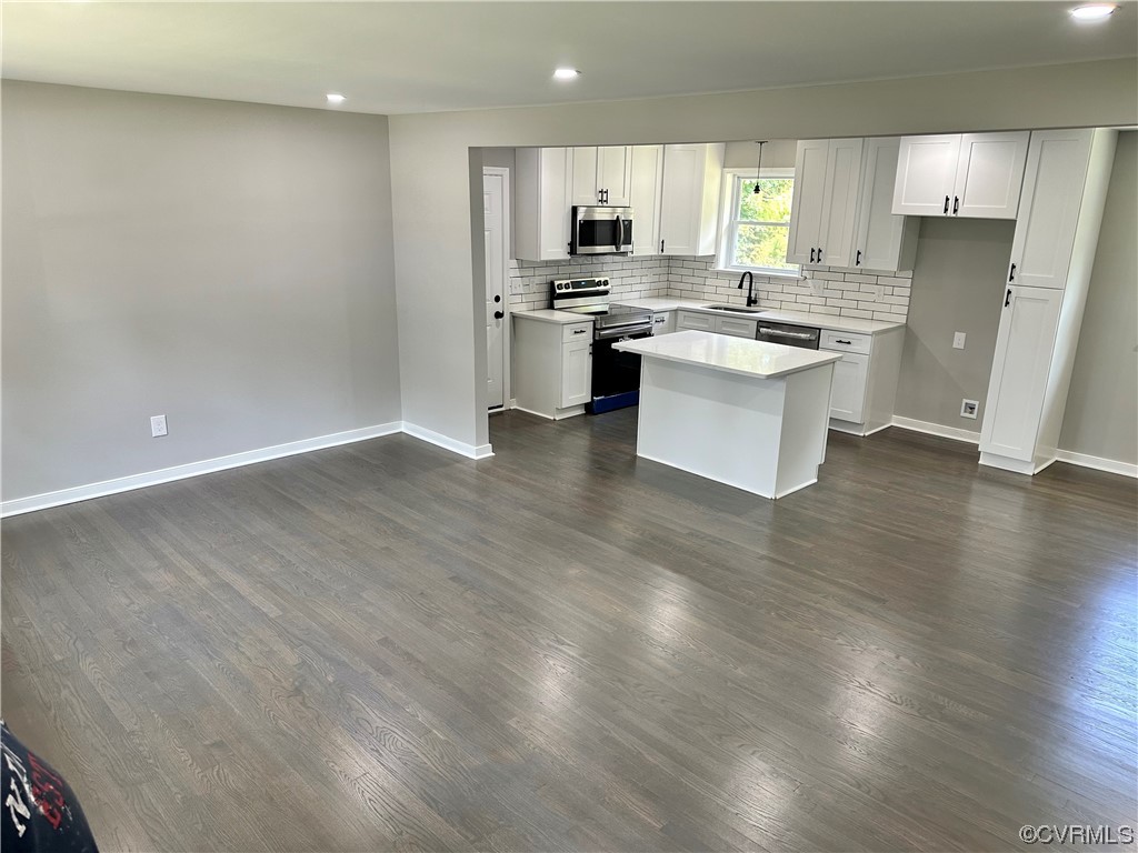 1035 Southam Drive Richmond, VA 23235 - Photo 7 of 43 a kitchen with stainless steel appliances a stove top oven a sink a refrigerator white cabinets and wooden floor