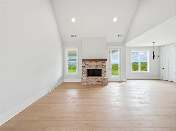 an empty room with wooden floor and a window