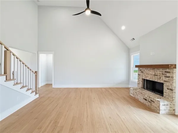 a view of a livingroom with a ceiling fan and window