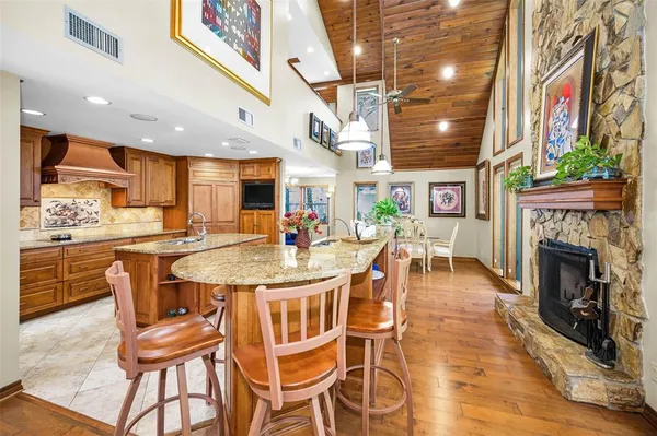 a kitchen with granite countertop a sink and a stove