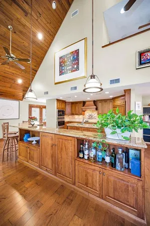 a kitchen with stainless steel appliances kitchen island granite countertop a sink and cabinets
