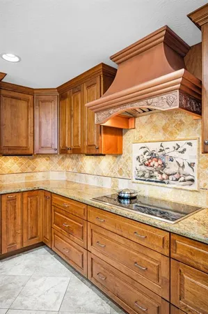 a kitchen with stainless steel appliances granite countertop a sink and a stove