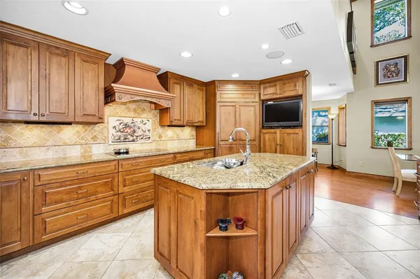 a living room with lots of furniture and kitchen view