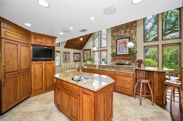 a view of a dining room with furniture a chandelier and wooden floor