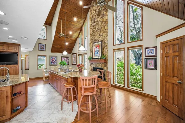 a spacious bedroom with a bed a dresser and wooden floor