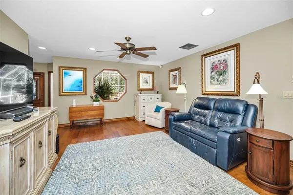 a living room with furniture and wooden floor