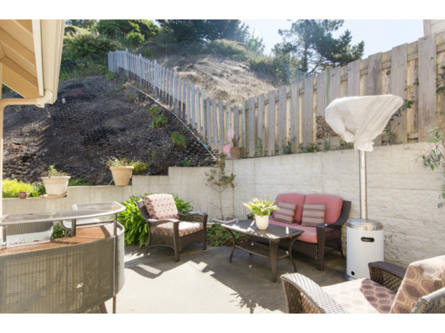 513 Monterey Road, Unit B Pacifica, CA 94044 - Photo 12 of 23 a backyard of a house with table and chairs
