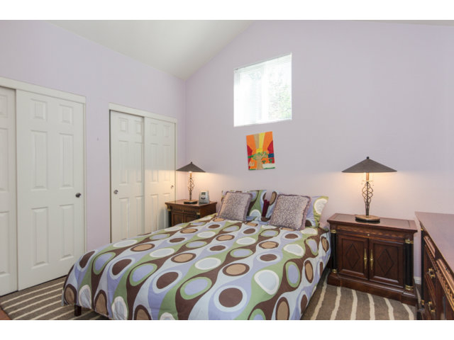 513 Monterey Road, Unit B Pacifica, CA 94044 - Photo 14 of 23 a bedroom with a bed and a lamp