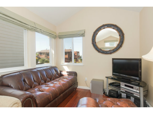 513 Monterey Road, Unit B Pacifica, CA 94044 - Photo 19 of 23 a living room with furniture a flat screen tv and a window