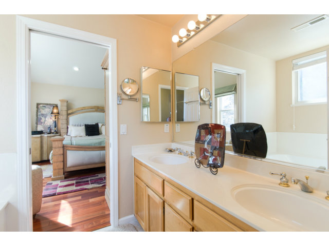 513 Monterey Road, Unit B Pacifica, CA 94044 - Photo 21 of 23 a bathroom with a double vanity sink and mirror