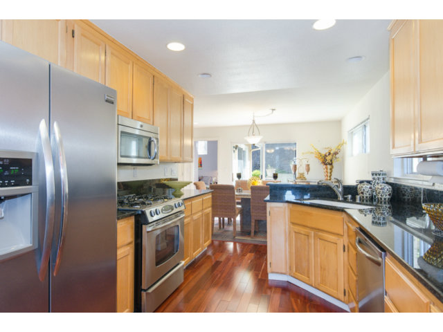 513 Monterey Road, Unit B Pacifica, CA 94044 - Photo 6 of 23 a kitchen with stainless steel appliances granite countertop a stove a sink dishwasher and a refrigerator