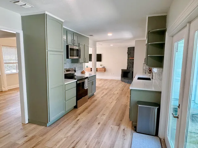 a kitchen with stainless steel appliances kitchen island wooden cabinets and granite counter tops