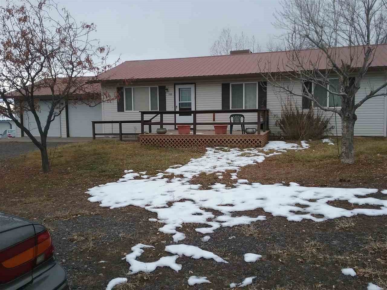 17825 Surface Creek Road Cedaredge, CO 81413 - Photo 1 of 24 a front view of a house with a yard
