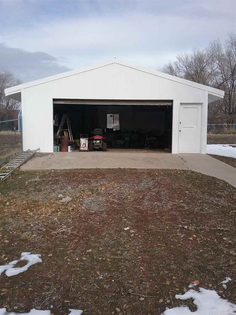 17825 Surface Creek Road Cedaredge, CO 81413 - Photo 2 of 24 a front view of a house with a yard