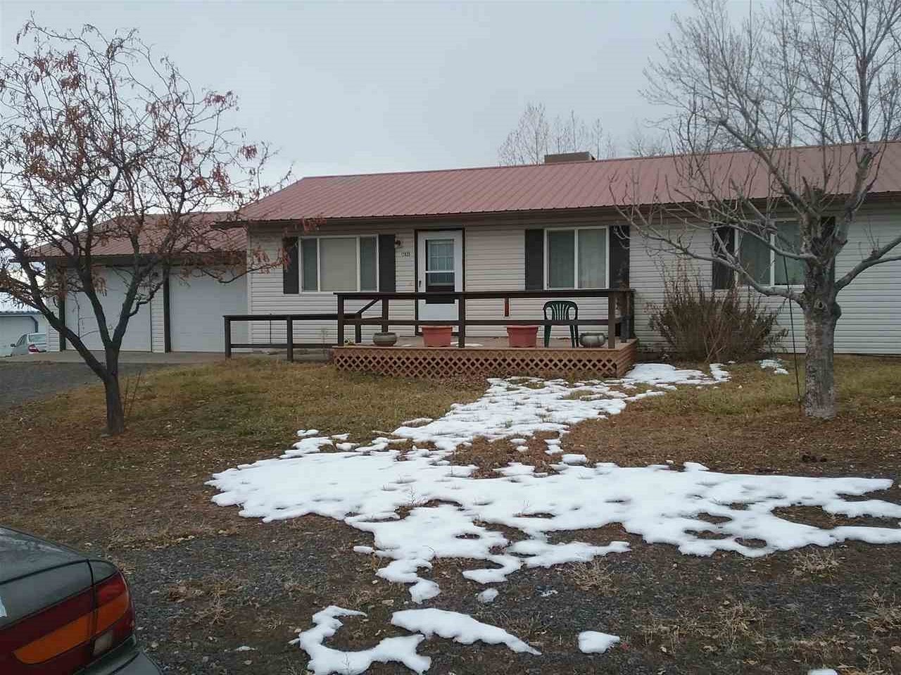 17825 Surface Creek Road Cedaredge, CO 81413 - Photo 22 of 24 a front view of a house with a yard