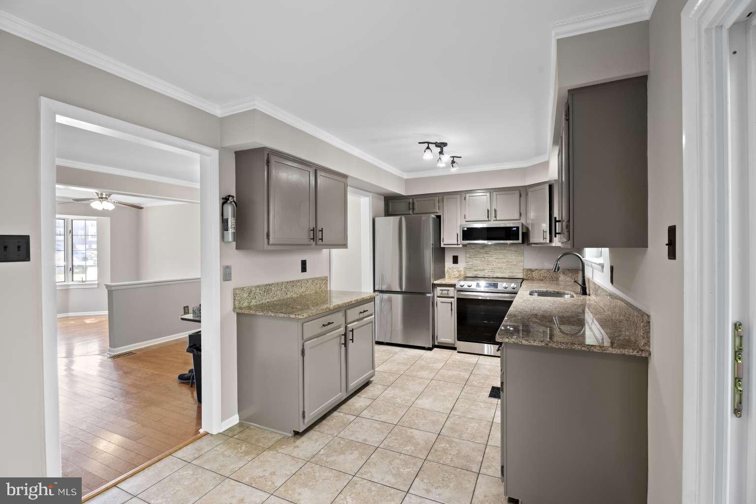 32 Millbridge Court Nottingham, MD 21236 - Photo 11 of 39 a kitchen with stainless steel appliances a stove sink and cabinets