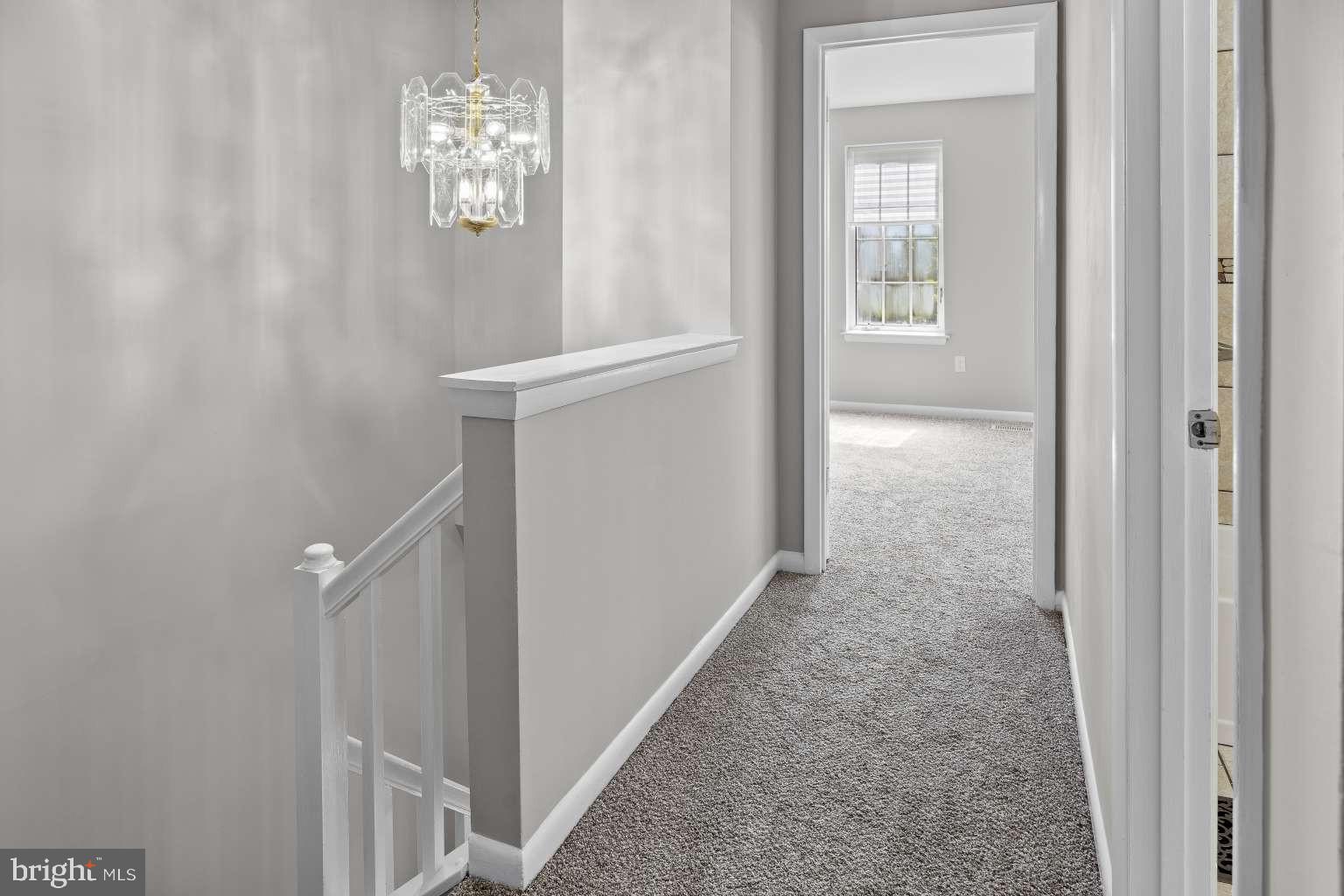 32 Millbridge Court Nottingham, MD 21236 - Photo 13 of 39 a view of a hallway with windows and chandelier