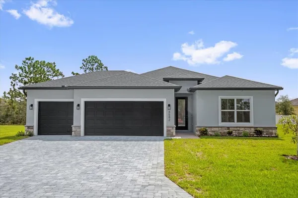 a view of a house with a yard and garage