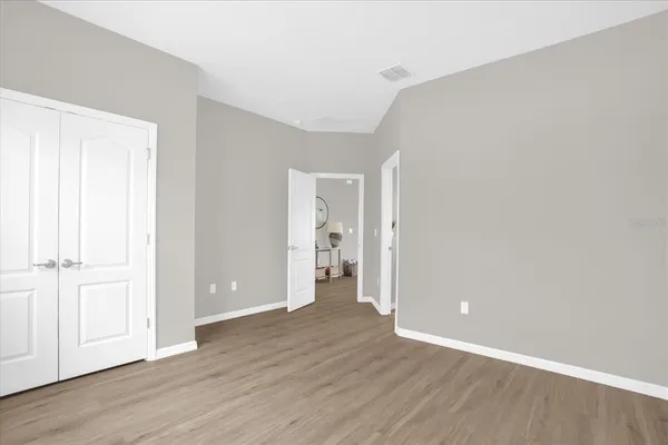 a view of an empty room with wooden floor