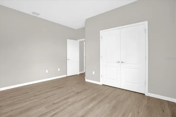 an empty room with wooden floor