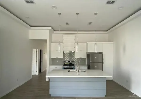 a view of kitchen with refrigerator and window
