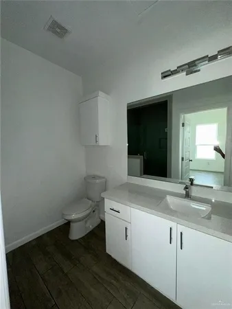 a bathroom with a sink toilet and mirror