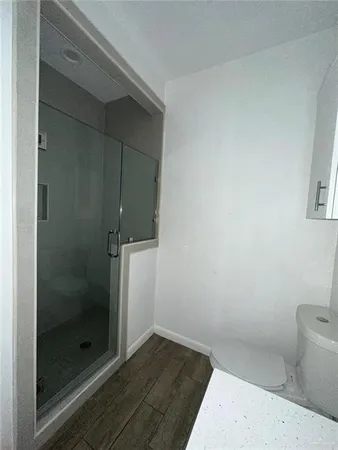 a bathroom with a shower and toilet
