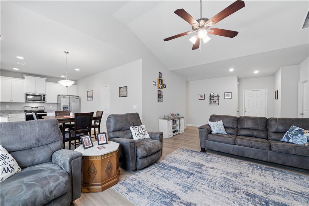 1269 Covered Bridge Road Covington, GA 30016 - Photo 5 of 31 a living room with furniture kitchen view and a chandelier