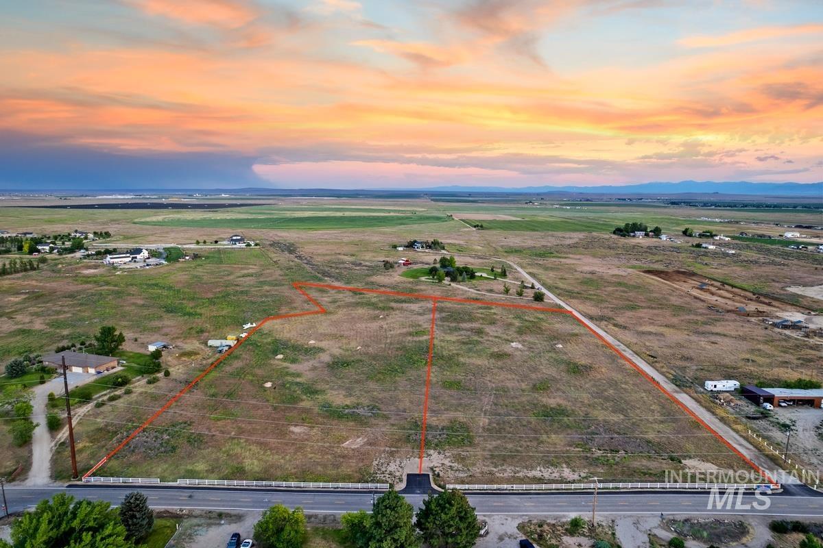9743 West Kuna Road Kuna, ID 83634 - Photo 2 of 5 Aerial view at dusk of property parcel outlined and a view of rural / pastoral area