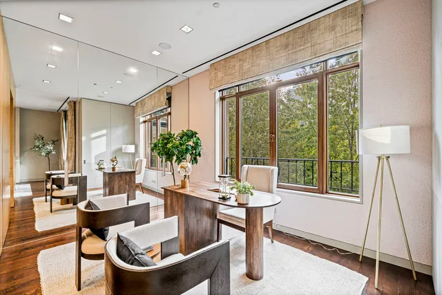 a room with lots of wooden furniture and a book shelf