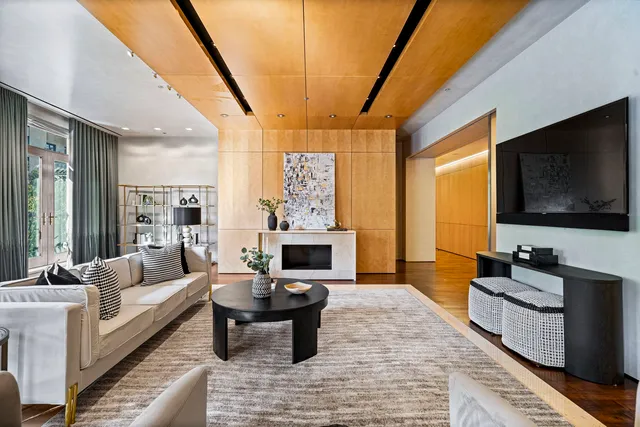 a living room with fireplace furniture and a flat screen tv