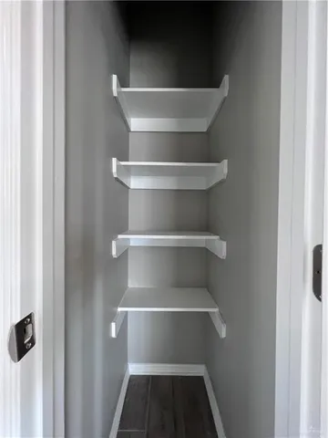 a view of walk in closet with empty racks
