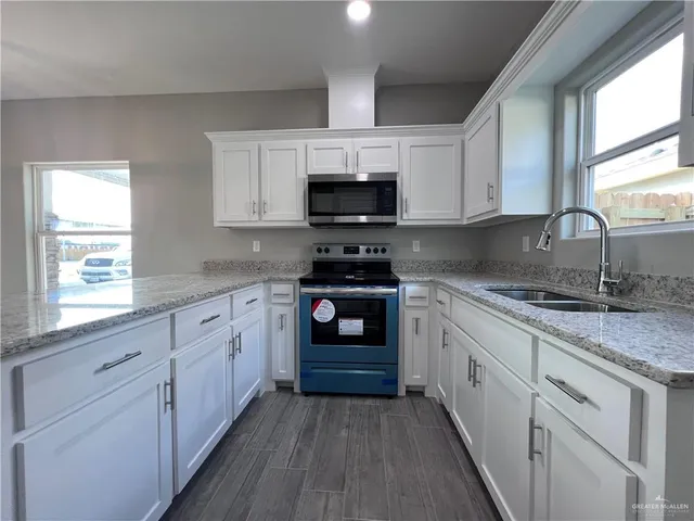 a kitchen with sink cabinets and window
