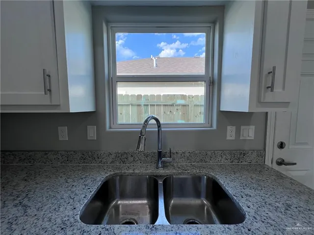 a kitchen with a sink and a window