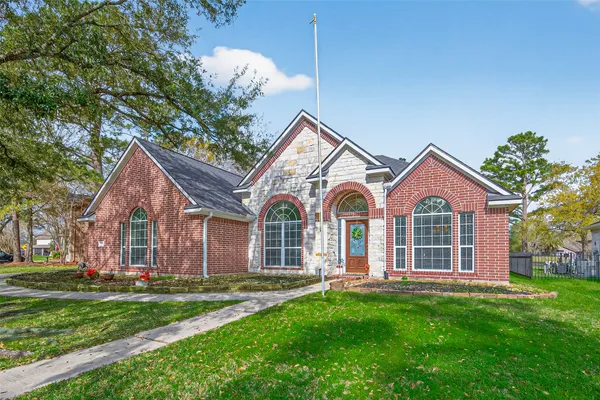 a front view of a house with a garden