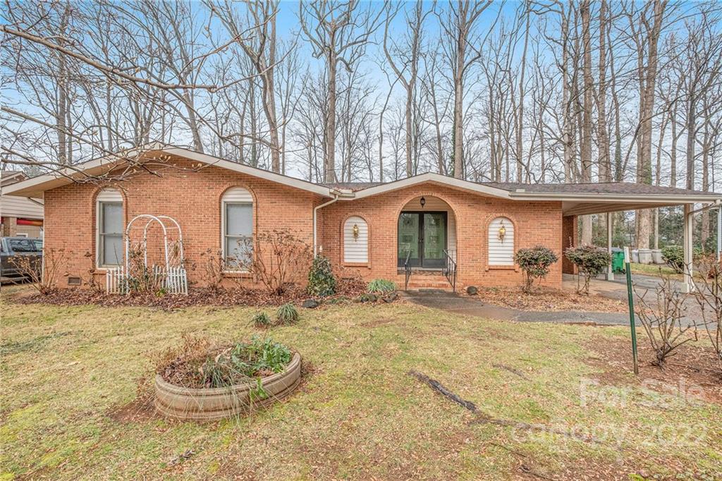 1446 McIlroy Road, Unit 8 Charlotte, NC 28212 - Photo 1 of 30 a backyard of a house with table and chairs