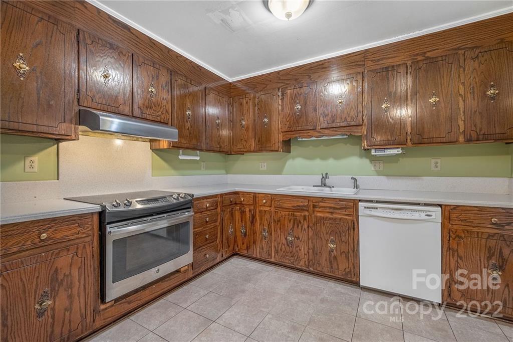 1446 McIlroy Road, Unit 8 Charlotte, NC 28212 - Photo 13 of 30 a kitchen with granite countertop stainless steel appliances wooden cabinets and a sink
