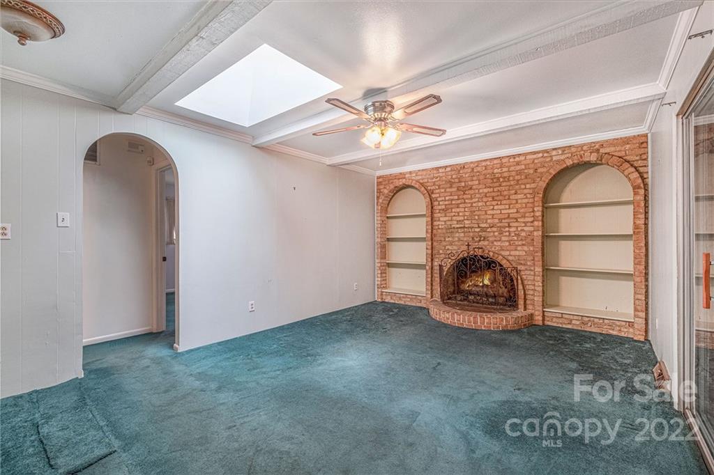 1446 McIlroy Road, Unit 8 Charlotte, NC 28212 - Photo 15 of 30 an empty room with windows dryer and fireplace