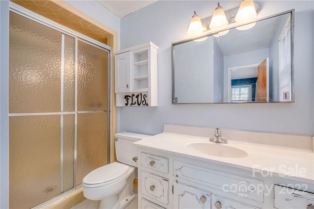 1446 McIlroy Road, Unit 8 Charlotte, NC 28212 - Photo 21 of 30 a bathroom with a sink a toilet and shower