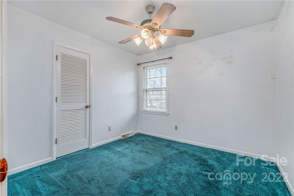 1446 McIlroy Road, Unit 8 Charlotte, NC 28212 - Photo 23 of 30 an empty room with closet and a chandelier fan