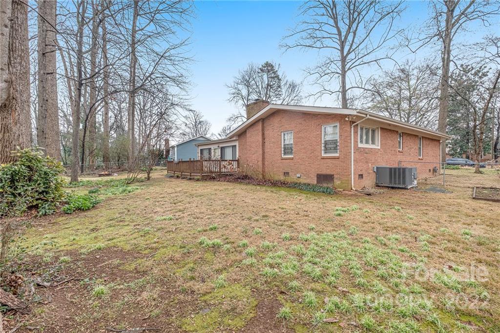 1446 McIlroy Road, Unit 8 Charlotte, NC 28212 - Photo 28 of 30 a white house that has a tree in front of it