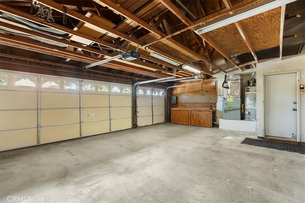 7158 Foxcroft Street Riverside, CA 92506 - Photo 33 of 51 Large garage with work bench and storage on both sides
